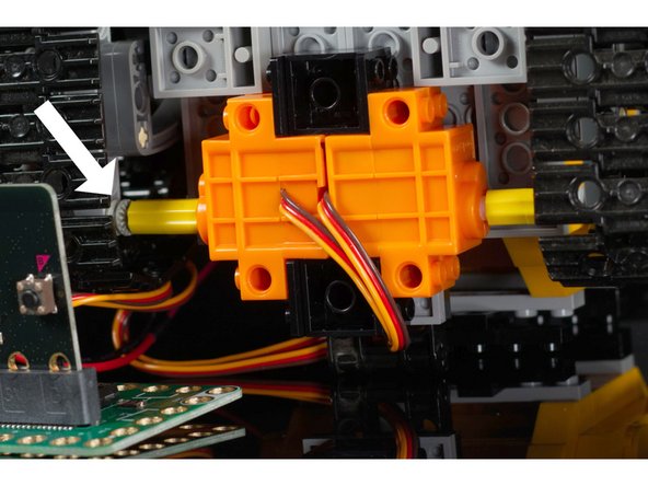 The LEGO Axle Connectors will go onto the shaft of the servo motors and connect to the LEGO Axle.  (The LEGO Technic Bush is used to hold the axle in place laterally.)