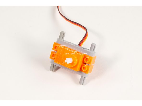 Slide the servo in place onto the axles.