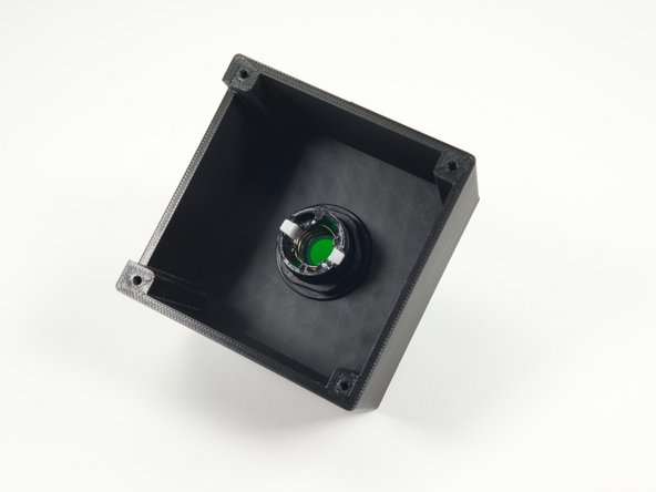 We've aligned the white tabs so that one is closest to the side with the slot in the button enclosure.