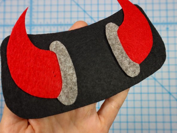 Use a push pin to make two holes for the LED's legs. When the push pin is inside the felt, rotate it around a bit to make the hole larger and easier to see.