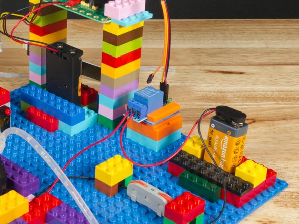 The Red (Positive) wire from the battery connector will go to the COM (Common) Screw Terminal on the Relay Module.