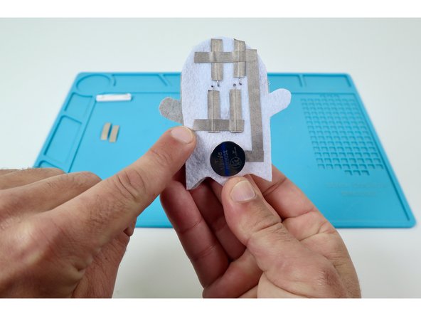 Peel and stick the three Maker Tape paths you cut in the previous guide step as shown in the photos at left. 