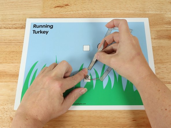 Add Tape Path A. pressing it down atop the blue wire.