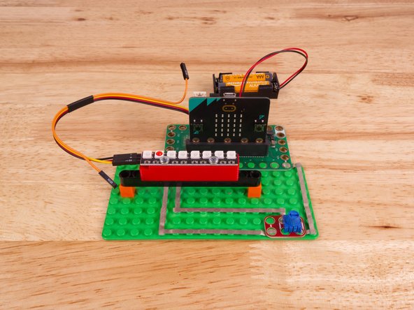 So let's get connected! If you turn the NeoPixel Strip over you'll see labels for the three pins. You should see IN, VCC, and GND.