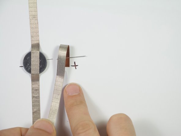 Adhere Maker Tape to the positive side of the LED, then continue to connect this piece with the piece of Maker Tape coming from the other side of the switch.