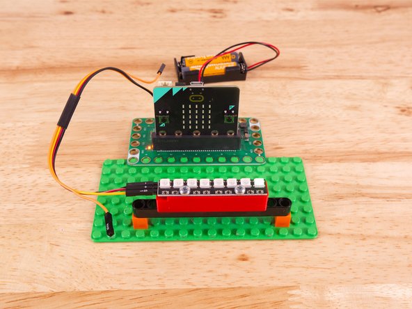 To mount the NeoPixel Stick in place we used our NeoPixel Beam Holder with a long Technic Beam and two 1x1 LEGO bricks.