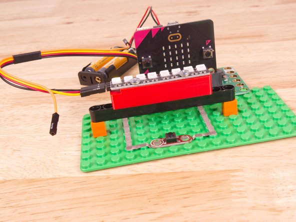 To mount the NeoPixel Stick in place we used our NeoPixel Beam Holder with a long Technic Beam and two 1x1 LEGO bricks.