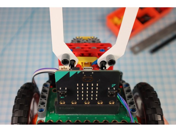 Unpin the pins from the half beams and use them to attach the arms as shown.