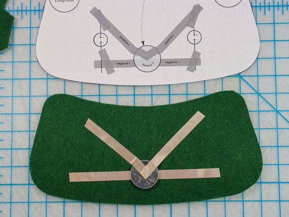 Place the battery on top of the Maker Tape as shown, and add the &quot;V&quot; shaped piece on top.