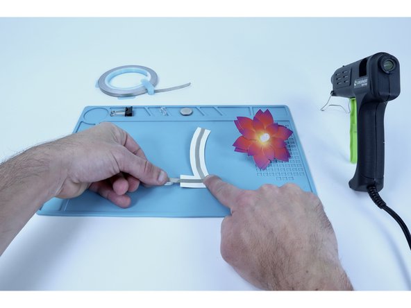 Peel and stick that new tape segment into place contacting the lower end of the last tape segment you placed, along the length of the tab, and around to the front of the tab.