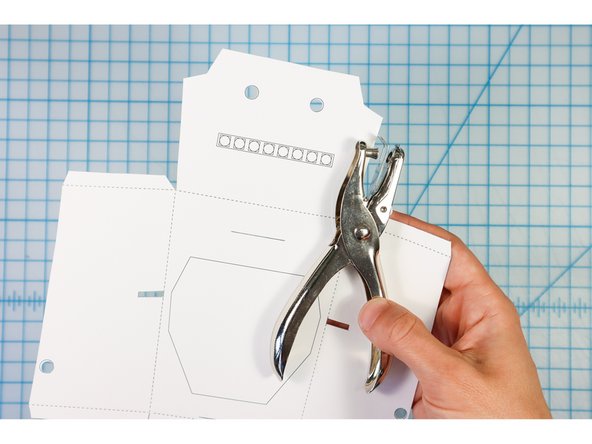 Use a standard hole punch to punch the circles.