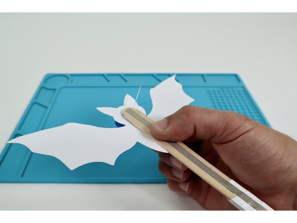 Fold the outer (short) LED legs down flat against the upward-facing side of the wand handle in a slight &quot;V&quot;.