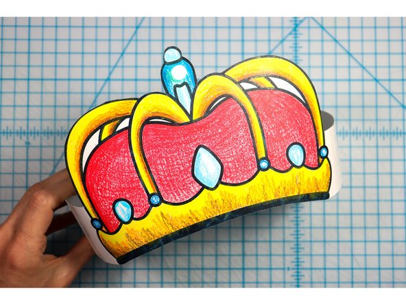 Cut out the side strips and tape them to the hat with the slits facing up on one side and down on the other. 