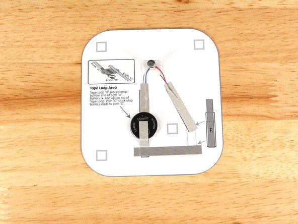 Add tape Path E. pressing it down atop the red wire.