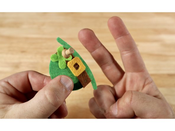 Use the push pin to poke two holes through the center of the shamrock (clover) in a vertically oriented column. Be careful not to poke yourself on the opposite side! These are holes that you will thread the LED legs through.