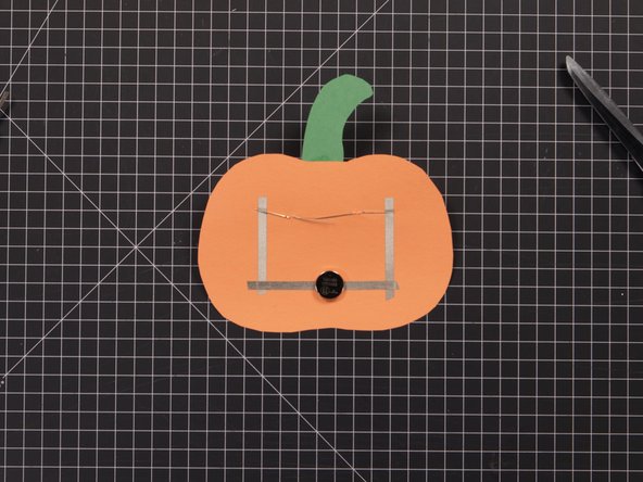 Stick the battery down to the Tape Loop with the nega- tive side down to the Tape Loop and the positive side facing up. (It’s the shiny side with a + sign on it.)