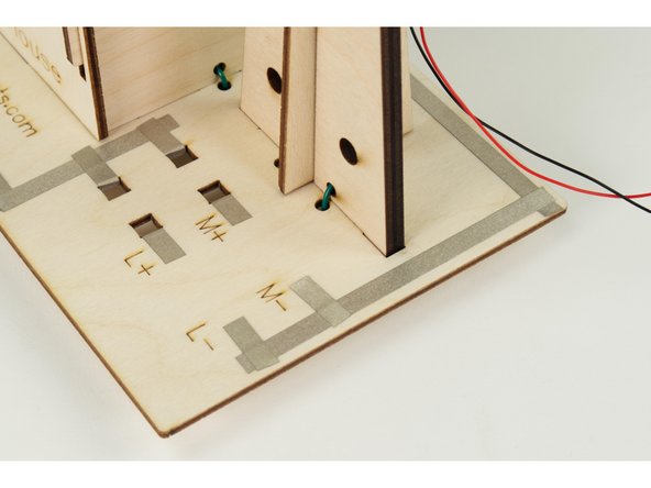 Insert the windmill assembly into the base, with the ends of the wire going into the holes on the base.
