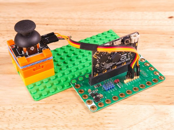 Plug the three-wire connector of the Crazy Circuits Ribbon Cable into the row with Pin 0 on the Bit Board. The wire colors should match the pin header colors, with S1 (yellow) going to the yellow pin.