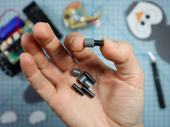 Connect each LEGO pin to a LEGO round beam as shown.