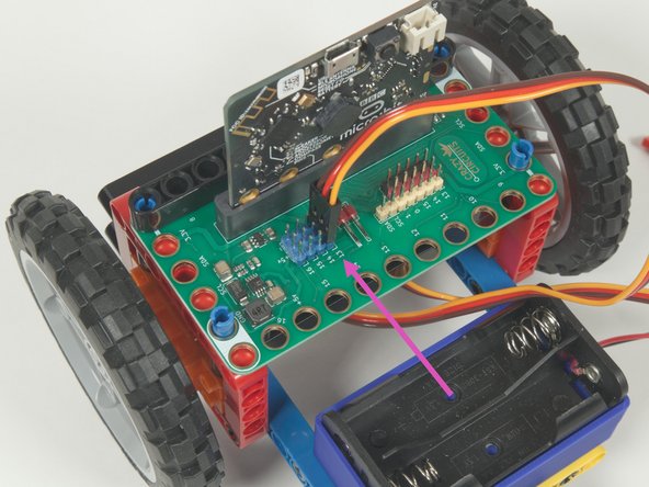 Plug the right servo into the row for Pin 14, matching the orientation of the servo connector for the left servo.