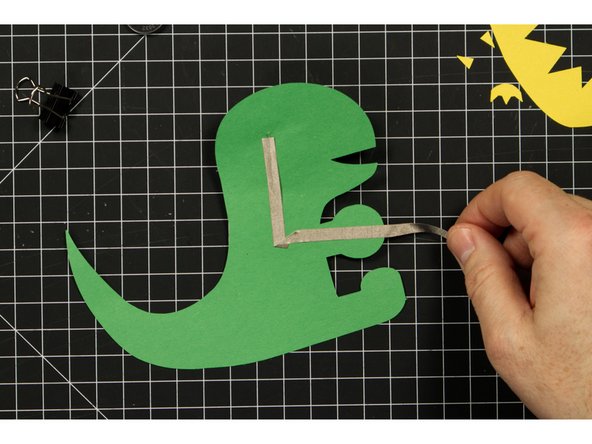 Run a piece of tape covering the positive LED leg, down and then over to the round battery holder piece.