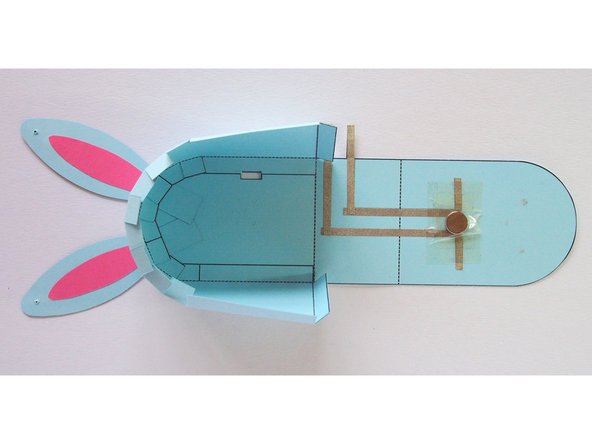 Make sure you're gluing it with the arrows on the side and body pointing towards each other (not shown in photo because I made the mistake of gluing this wrong! I had to poke new holes for the thread)