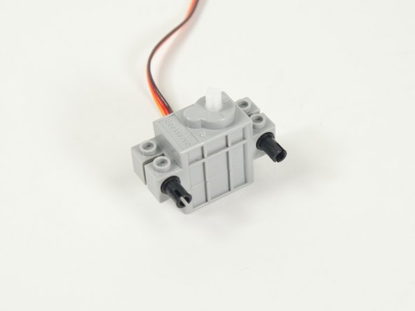 Add two black pins to the servo.