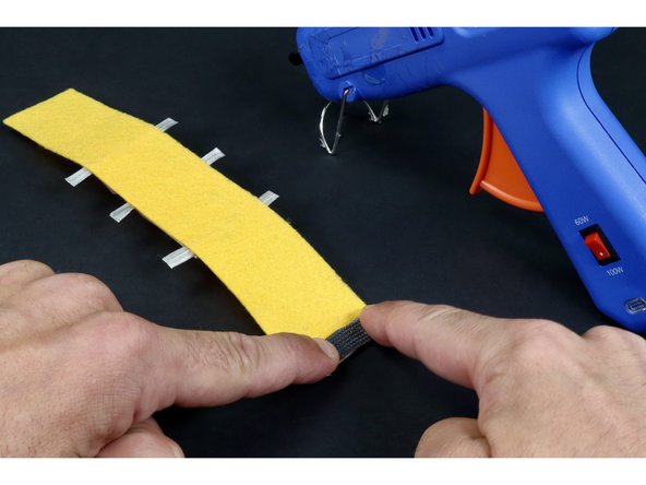 Continue by hot gluing the remaining portion of the conductive hook and loop on top using two dots of glue on either side of the tape loop. Remember: do NOT add hot glue on top of the loop...only the areas to the right and left of it.