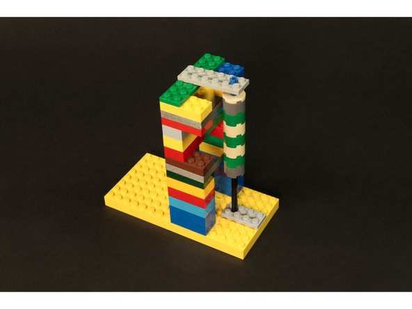 It should be positioned so it is touching the upper and lower strips of Maker Tape and so that it can rotate freely.