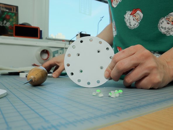 Use a hole punch to punch out each of the outer holes, and an awl to put a hole thru the inner holes.