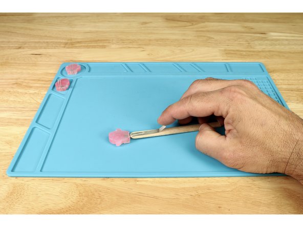 Peel and stick the shorter tape path atop the long positive leg on the opposite side.