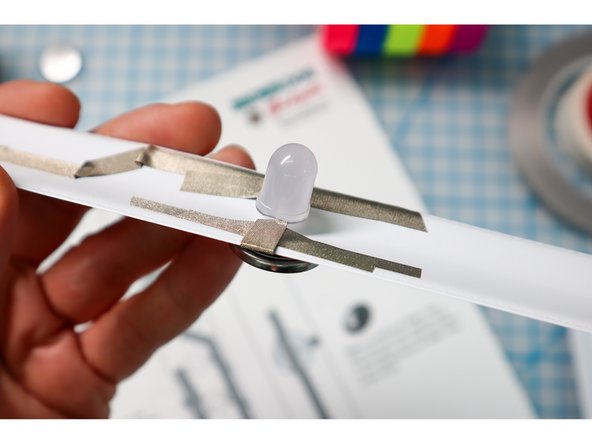 Follow the template to wrap a piece of Maker Tape around the edge to the inside of the bracelet as shown.