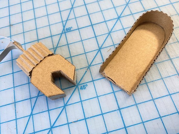 We added Maker Tape around each side of one of the hands to act as a touch-switch when you give her a high-five.