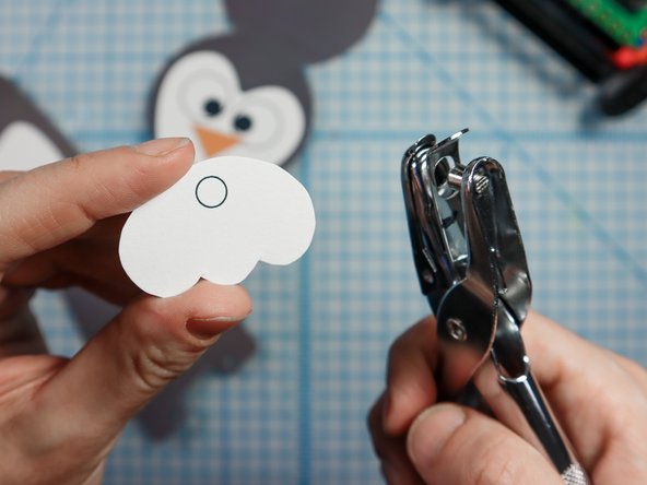 Use a standard hole punch to punch out the circled where shown.