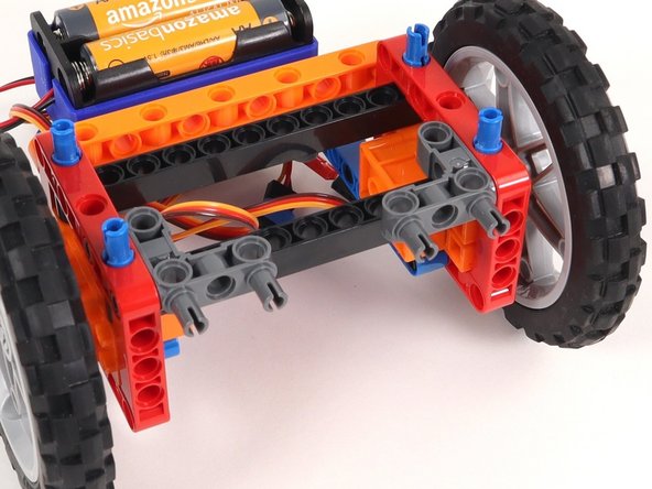 Add two gray 90° connectors to the Rover as shown. One side should connect to the inside of a red frame and the other pins should stick out towards the front of the Rover.