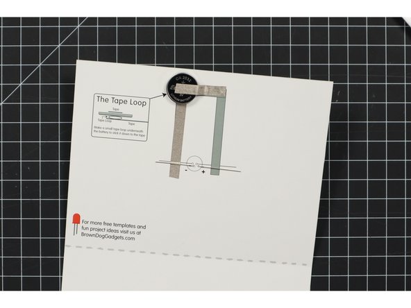 Stick a piece of Maker Tape on top of the battery and run it to the side.