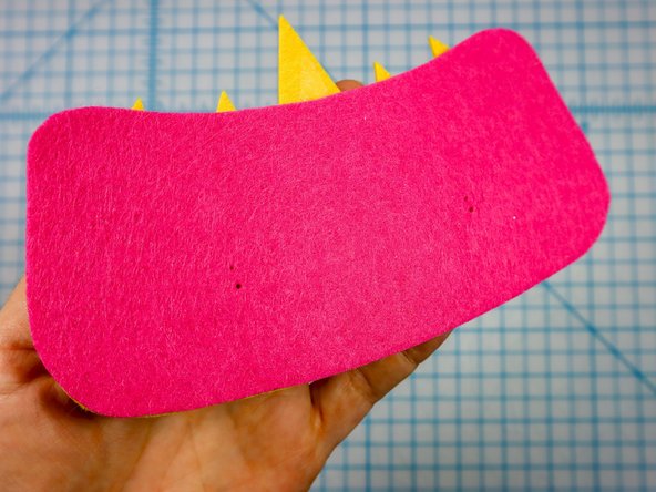 Use a push pin to make two holes for the LED's legs. When the push pin is inside the felt, rotate it around a bit to make the hole larger and easier to see.