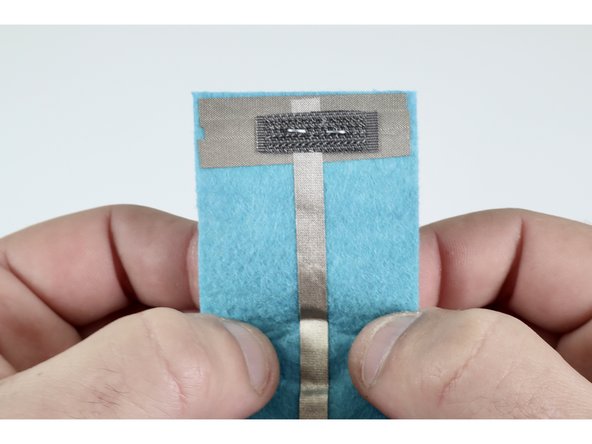 Staple once through everything. The staple will bring the Hook &amp; Loop, Maker Tape Loop and widened conductive end of your circuit all into constant contact.