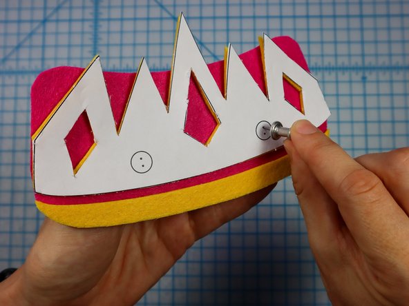 Use a push pin to make two holes for the LED's legs. When the push pin is inside the felt, rotate it around a bit to make the hole larger and easier to see.