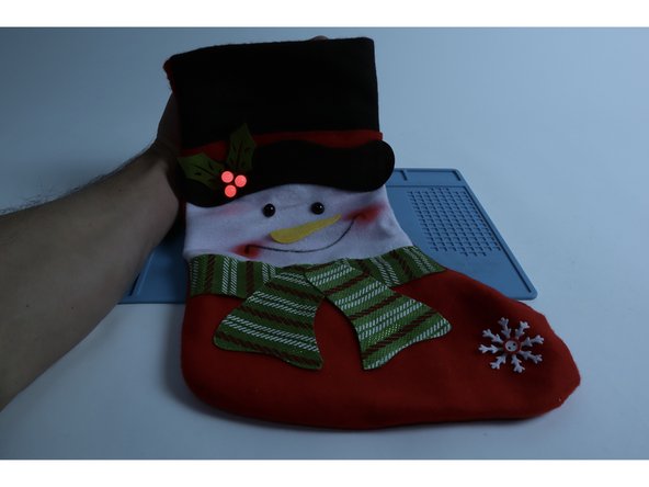 TIP: Oftentimes a circuit gets jostled out of working condition when the stocking is turned right-side-out. The LED may flicker or not work at all. If you encounter this issue, try pressing/firming up every connection point within the circuit where either an LED leg meets the tape OR where one piece of Maker Tape is connected to another!