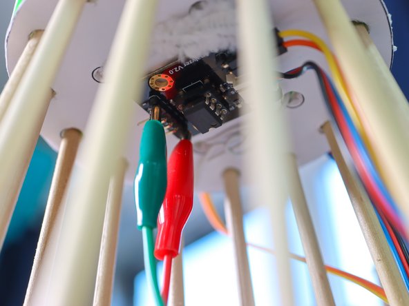 Alternatively to using a splitter, you could use your computer and play the music from the phone's speaker and headphones as a multi-output device.