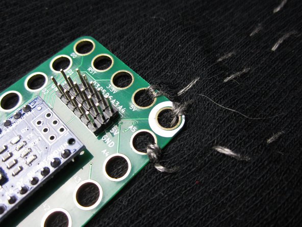 We connected the 5V, Ground (Negative) and A5 pins. It doesn't matter which holes on the Header you connect to, as long as you're not crossing lines of thread.  That would cause shorts.