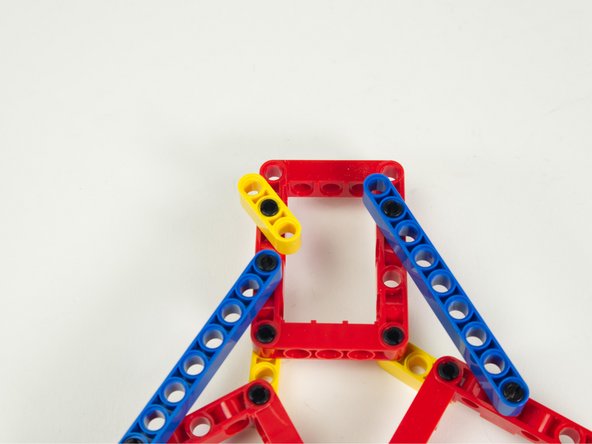 Insert this pin and beam combo into the hole in a red frame as shown.