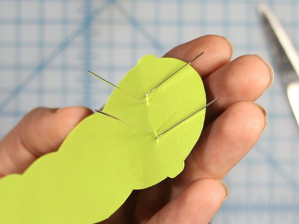 Fold the negative, or shorter wires flat against the back of the worms head.