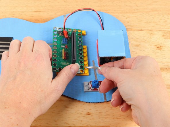 Replace the potentiometer to help secure the tape path in place.