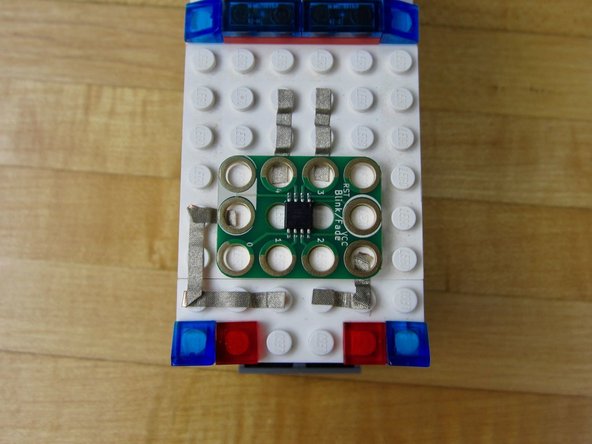Use anther line of tape to connect Hole 4 to the other LED.