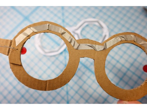 Fold the shorter, innermost legs down flat against the Maker Tape.