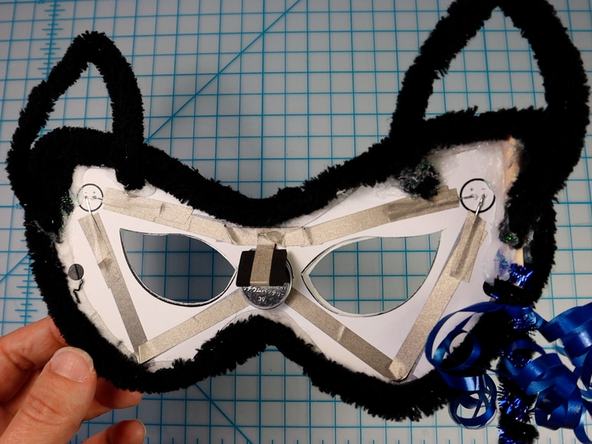 Make two triangles with another piece of pipe cleaner to make the ears and glue them in place.