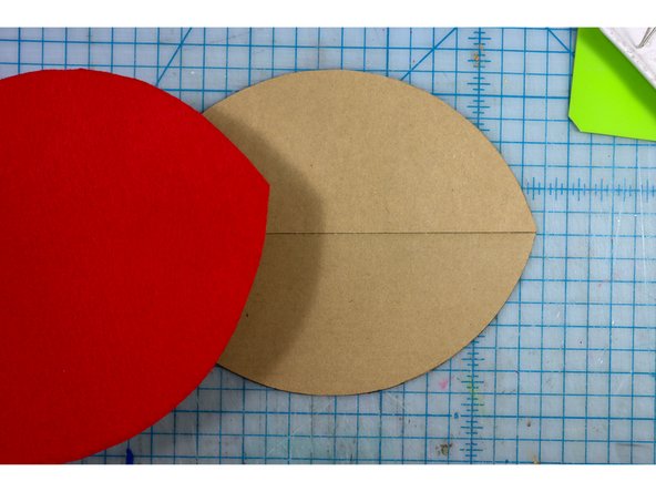 Place the cardboard mouth pieces together as shown, and glue the red felt piece on top of it.