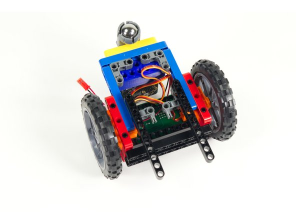 Add the black 11 beams to each set of of pins so the beams stick out the front of the Rover.